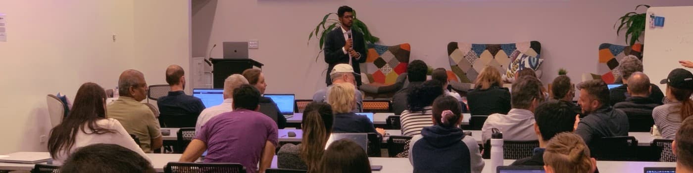 Arun Prakash teaching a live workshop - a room of founders on laptops following along